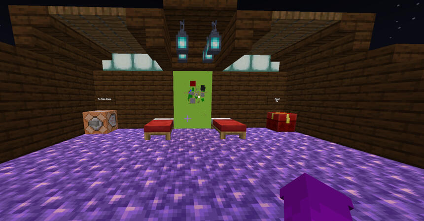 The spawn area An image of a small room built out of spruce wood. Theres 2 red beds, a command block on the left with a sign labled "To main base" with a button on the front face, a map between the beds, and a chest on the right labled "read me"