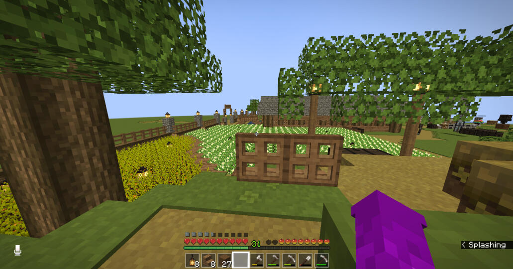 A picture of the main server farm, with a bench in the foreground. From the vantage point, you can see the potatoes and carrots, with the trading hall in the distance, framed by a low effort canopy beside the bench.